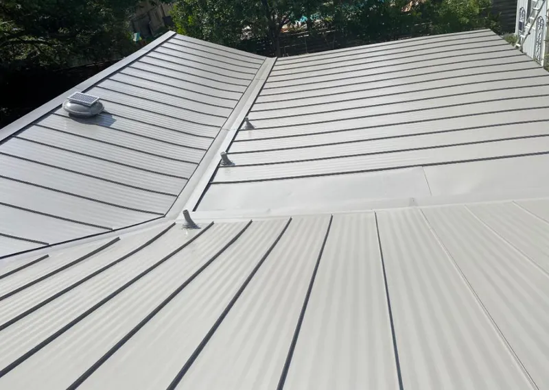 Solar attic fan installed on a metal roof for Roof Ventilation in Stratham